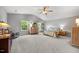 Spacious bedroom with ceiling fan, natural lighting, carpet floors, with matching dressers and a full bed at 6102 Coronado Ln, Durham, NC 27713