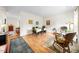 Comfortable dining room and living area with wood flooring, area rugs, and natural light at 6102 Coronado Ln, Durham, NC 27713