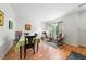 Bright dining area with light walls, wood floors, and a view to a well appointed seating area at 6102 Coronado Ln, Durham, NC 27713