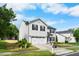 Well-manicured two-story home featuring a two-car garage, neat lawn, and classic design elements under a blue sky at 6102 Coronado Ln, Durham, NC 27713