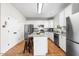 Stylish kitchen with granite countertops, stainless steel appliances, white cabinets and hardwood floors at 6102 Coronado Ln, Durham, NC 27713