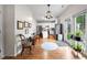 Open-concept kitchen with stainless steel appliances, white cabinets, and hardwood flooring, perfect for cooking at 6102 Coronado Ln, Durham, NC 27713