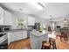 Bright kitchen with granite countertops, stainless steel appliances and hardwood floors connecting to the living room at 6102 Coronado Ln, Durham, NC 27713
