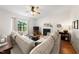 Spacious living room features a decorative fireplace, plush sofa, and abundant natural light from a window at 6102 Coronado Ln, Durham, NC 27713