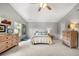Large main bedroom with vaulted ceiling, natural lighting, and ceiling fan, carpet floors at 6102 Coronado Ln, Durham, NC 27713
