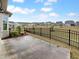 Backyard with a concrete patio, black fence, and a view of the neighborhood at 611 Atticus Way, Durham, NC 27703