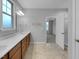 Bathroom featuring a long vanity with double sinks and a doorway to the main bedroom at 611 Atticus Way, Durham, NC 27703