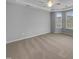 Bright bedroom with neutral walls, carpet, and lots of natural light from large windows at 611 Atticus Way, Durham, NC 27703