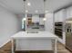Beautiful kitchen with white cabinets, stainless steel appliances, and center island at 611 Atticus Way, Durham, NC 27703
