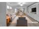 Bright, open-concept living room with hardwood floors and a view to the kitchen at 611 Atticus Way, Durham, NC 27703
