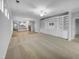Open-concept living room featuring hardwood floors and built-in shelving at 611 Atticus Way, Durham, NC 27703