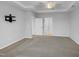 Spacious primary bedroom with neutral walls, a tray ceiling, and carpet floors at 611 Atticus Way, Durham, NC 27703