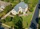 Aerial view of a well-maintained home with lush landscaping, a spacious yard, and a paved driveway at 642 Bear Tree Creek, Chapel Hill, NC 27517