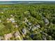 Breathtaking aerial view of golf course community homes surrounded by green trees and stunning views at 642 Bear Tree Creek, Chapel Hill, NC 27517