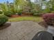 Spacious backyard patio perfect for outdoor entertaining, featuring a well-maintained lawn and mature landscaping at 642 Bear Tree Creek, Chapel Hill, NC 27517