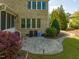 Backyard patio with brick accents, lush greenery, and an inviting space for relaxation at 642 Bear Tree Creek, Chapel Hill, NC 27517
