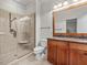 Bathroom with granite countertops, walk-in shower, and neutral tile at 642 Bear Tree Creek, Chapel Hill, NC 27517