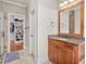 Bathroom featuring a granite countertop vanity and doorway to the walk-in closet at 642 Bear Tree Creek, Chapel Hill, NC 27517