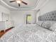 Comfortable bedroom featuring a patterned bedspread, decorative ceiling trim, and an ensuite bathroom at 642 Bear Tree Creek, Chapel Hill, NC 27517