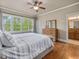 Bedroom showcasing a large window, hardwood floors, and access to bathroom at 642 Bear Tree Creek, Chapel Hill, NC 27517