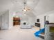 Spacious bonus room featuring a sectional sofa, wet bar, playroom area, and neutral carpet at 642 Bear Tree Creek, Chapel Hill, NC 27517
