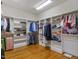 Spacious walk-in closet featuring built-in shelving and hardwood floors at 642 Bear Tree Creek, Chapel Hill, NC 27517