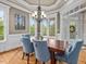 Dining area showcasing large windows, stylish seating, and elegant trim work at 642 Bear Tree Creek, Chapel Hill, NC 27517