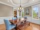 Dining room boasts hardwood floors, large windows, and a stylish chandelier at 642 Bear Tree Creek, Chapel Hill, NC 27517