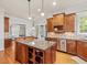 This kitchen has a center island, stainless steel appliances, and wood cabinets at 642 Bear Tree Creek, Chapel Hill, NC 27517