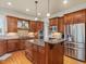 Gourmet kitchen with custom cabinets, stainless steel appliances, granite countertops, and a center island at 642 Bear Tree Creek, Chapel Hill, NC 27517