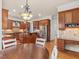 Gourmet kitchen with custom cabinets, stainless steel appliances, granite countertops, and a center island at 642 Bear Tree Creek, Chapel Hill, NC 27517