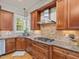 This kitchen has granite countertops, wooden cabinets, stainless steel appliances, and a gas cooktop at 642 Bear Tree Creek, Chapel Hill, NC 27517