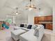 Comfortable living room featuring a sectional sofa, wet bar with wood cabinets, and ceiling fans at 642 Bear Tree Creek, Chapel Hill, NC 27517