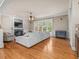 Open living room featuring hardwood floors, a fireplace, built-in shelves, and ample natural light at 642 Bear Tree Creek, Chapel Hill, NC 27517