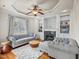 Bright living room boasts built-in bookshelves, a fireplace, hardwood floors, and large windows at 642 Bear Tree Creek, Chapel Hill, NC 27517