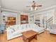 Open-concept living room with hardwood floors, plush sofa, and seamless connection to the kitchen and dining area at 642 Bear Tree Creek, Chapel Hill, NC 27517