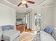Cozy living room with hardwood floors, a ceiling fan, and access to a bedroom and outdoor balcony at 642 Bear Tree Creek, Chapel Hill, NC 27517