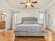 Spacious main bedroom features a tray ceiling, hardwood floors, and ensuite bathroom access at 642 Bear Tree Creek, Chapel Hill, NC 27517