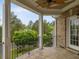 Spacious tiled patio with brick and white columns offering views of the surrounding trees and neighborhood at 642 Bear Tree Creek, Chapel Hill, NC 27517