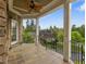 Covered patio with tile flooring, brick columns, and wrought iron railing overlooking the neighborhood at 642 Bear Tree Creek, Chapel Hill, NC 27517
