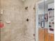 Tile shower featuring a built-in soap dish and glass doors that open to the walk-in closet at 642 Bear Tree Creek, Chapel Hill, NC 27517