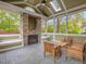 Cozy sunroom featuring a stone fireplace, vaulted ceilings, and panoramic views of the surrounding landscape at 642 Bear Tree Creek, Chapel Hill, NC 27517