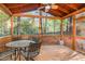 Cozy back porch featuring a wood ceiling, screen, and a patio table with four chairs at 707 Cross Timbers Dr, Durham, NC 27713