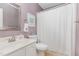 Clean bathroom features lavender walls, white cabinets, and a well-lit mirror above the sink at 707 Cross Timbers Dr, Durham, NC 27713
