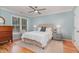 Comfortable bedroom with a ceiling fan, hardwood floors, and a large window at 707 Cross Timbers Dr, Durham, NC 27713