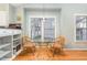 Bright dining area with hardwood floors, a glass table, and a window view at 707 Cross Timbers Dr, Durham, NC 27713