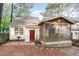 View of home's backyard with a screened-in porch and grill, ideal for entertaining at 707 Cross Timbers Dr, Durham, NC 27713