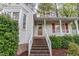Charming home exterior with brick stairs, white railings, and well-maintained landscaping at 707 Cross Timbers Dr, Durham, NC 27713