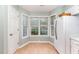 Bright kitchen nook with a corner full of windows, white appliances and light wood flooring at 707 Cross Timbers Dr, Durham, NC 27713