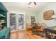 Cozy living area with wood floors, decor, a ceiling fan, and a glass door to the outside deck at 707 Cross Timbers Dr, Durham, NC 27713